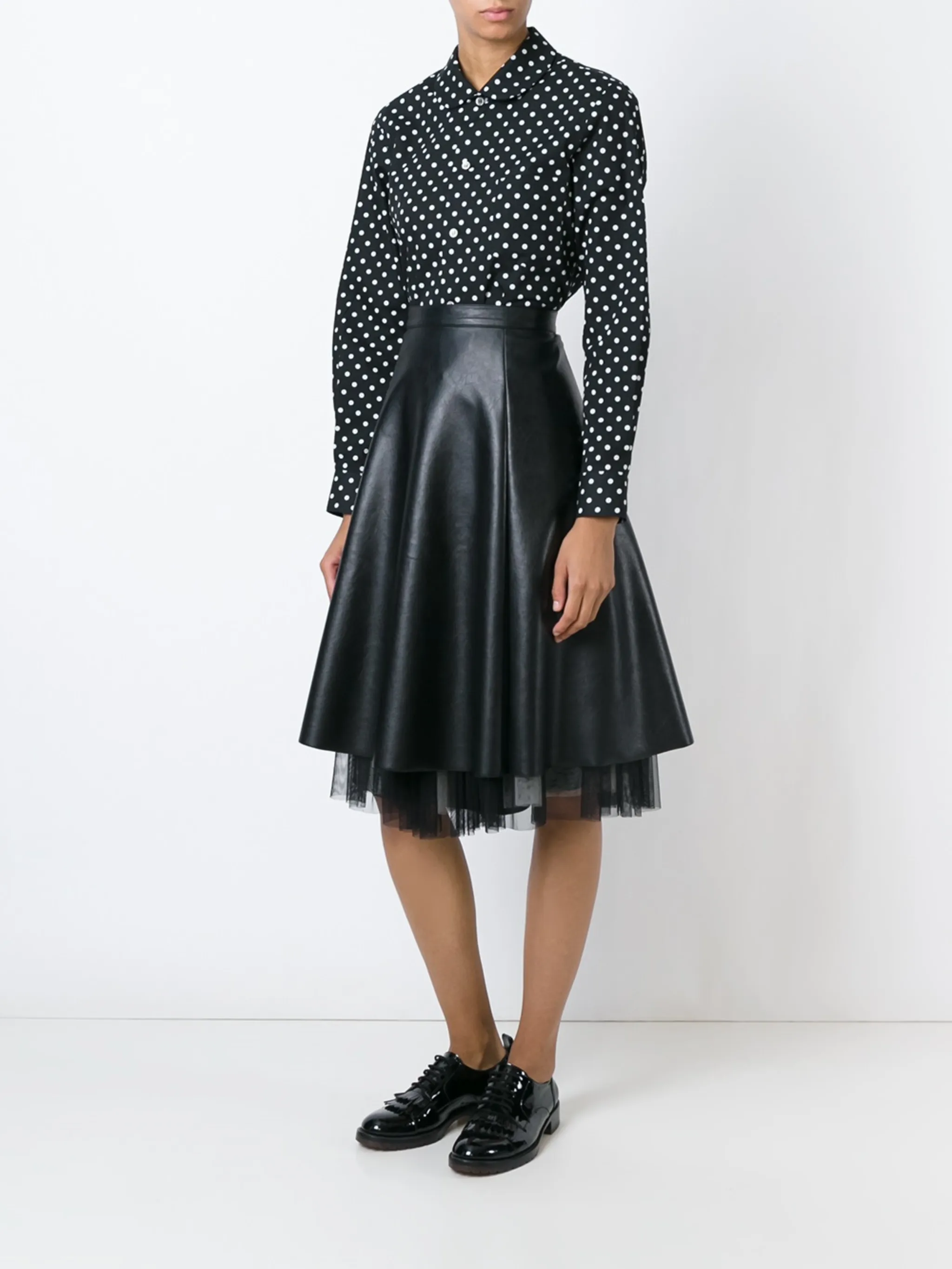 Black shirt  worn by a person, showing the shirt's fit