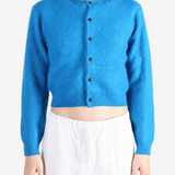 Blue knitwear worn by a person, showing the knitwear fit
