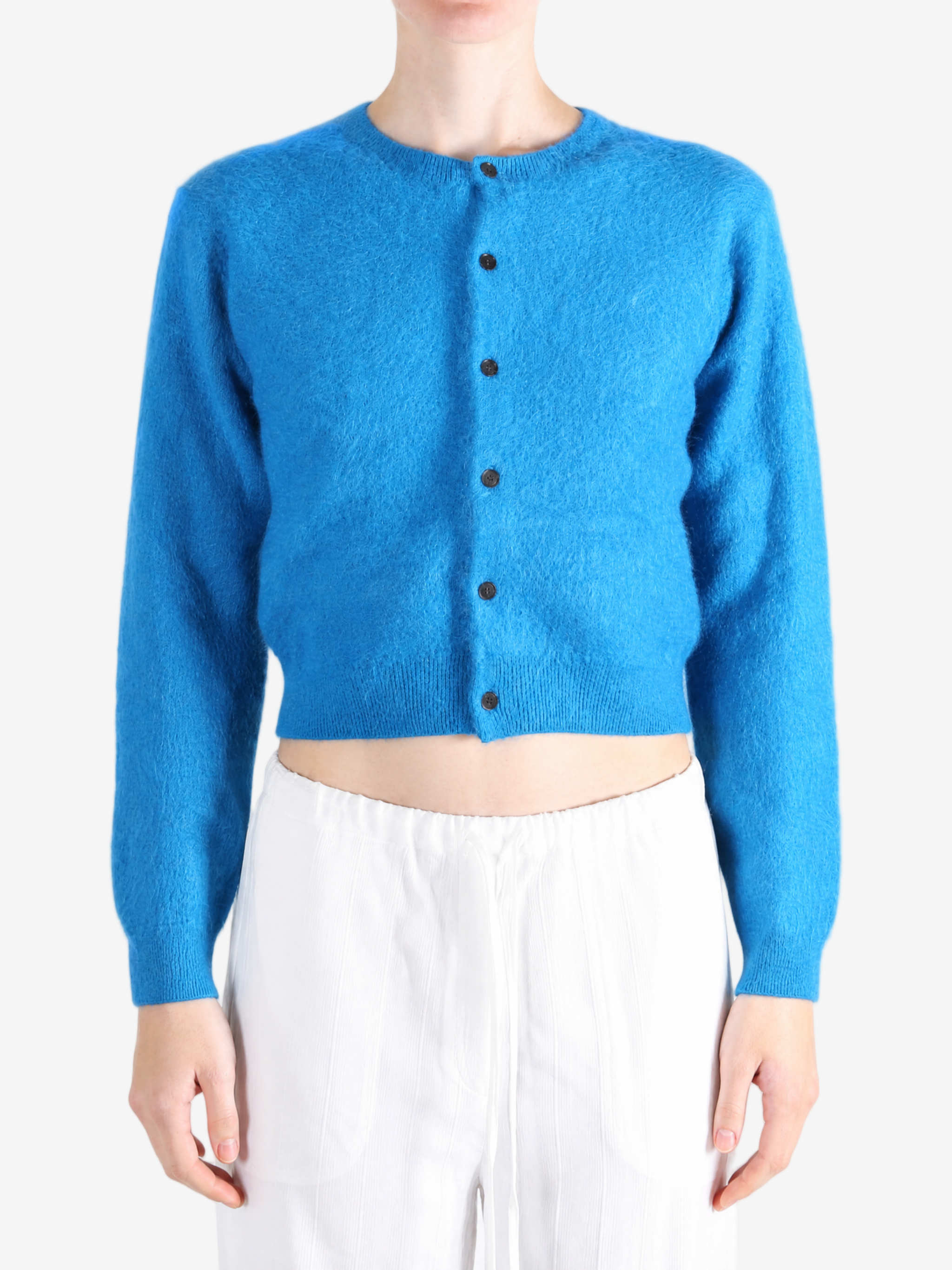 Blue knitwear worn by a person, showing the knitwear fit