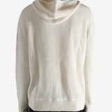 White knitwear worn by a person, showing the knitwear's fit