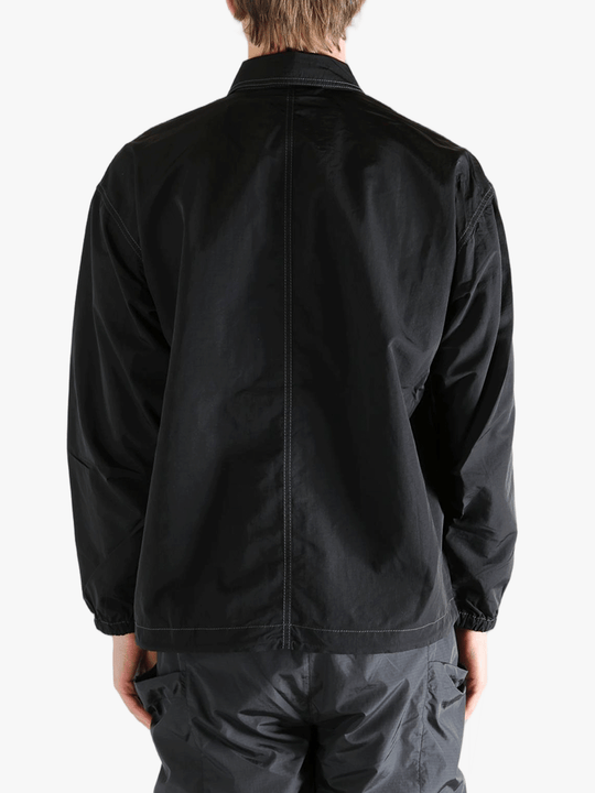 Black jackets worn by a person, showing the jackets fit