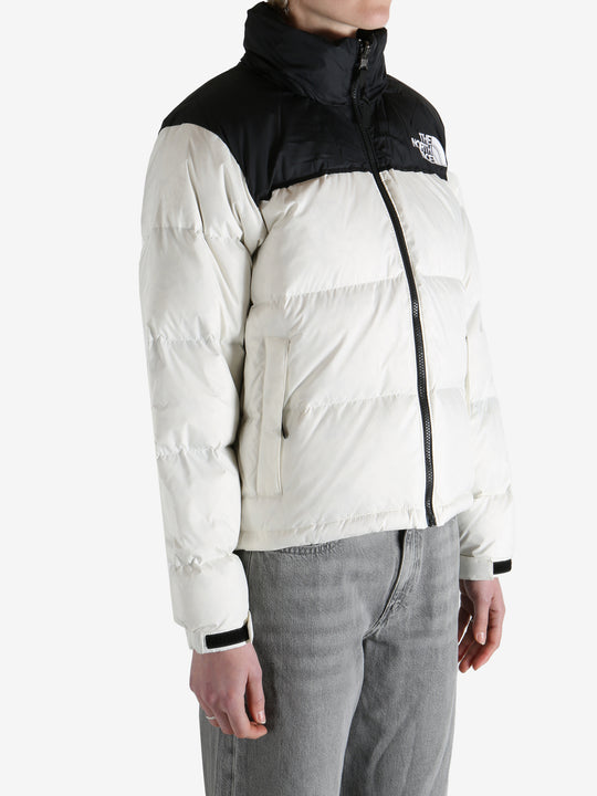  white jacket worn by a person, showing the jacket  fit