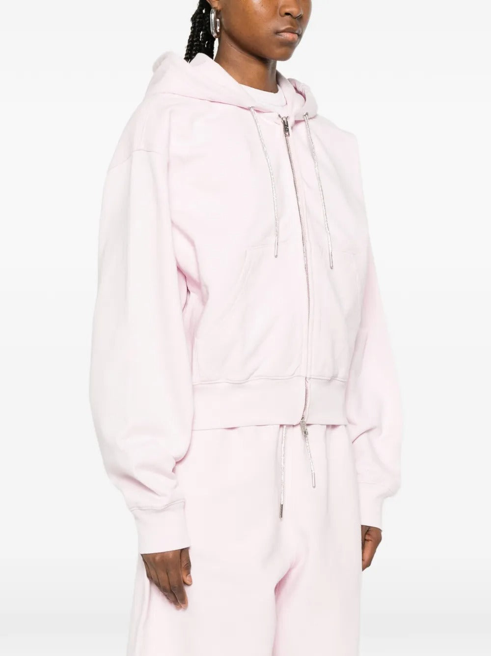 Pink hoodie worn by a person, showing the hoodie's fit