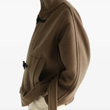 Brown jacket worn by a person, showing the jacket fit