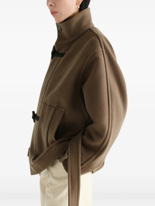 Brown jacket worn by a person, showing the jacket fit
