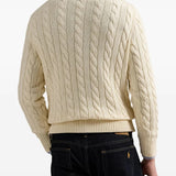 Creme sweater worn by a person, showing the sweater's fit