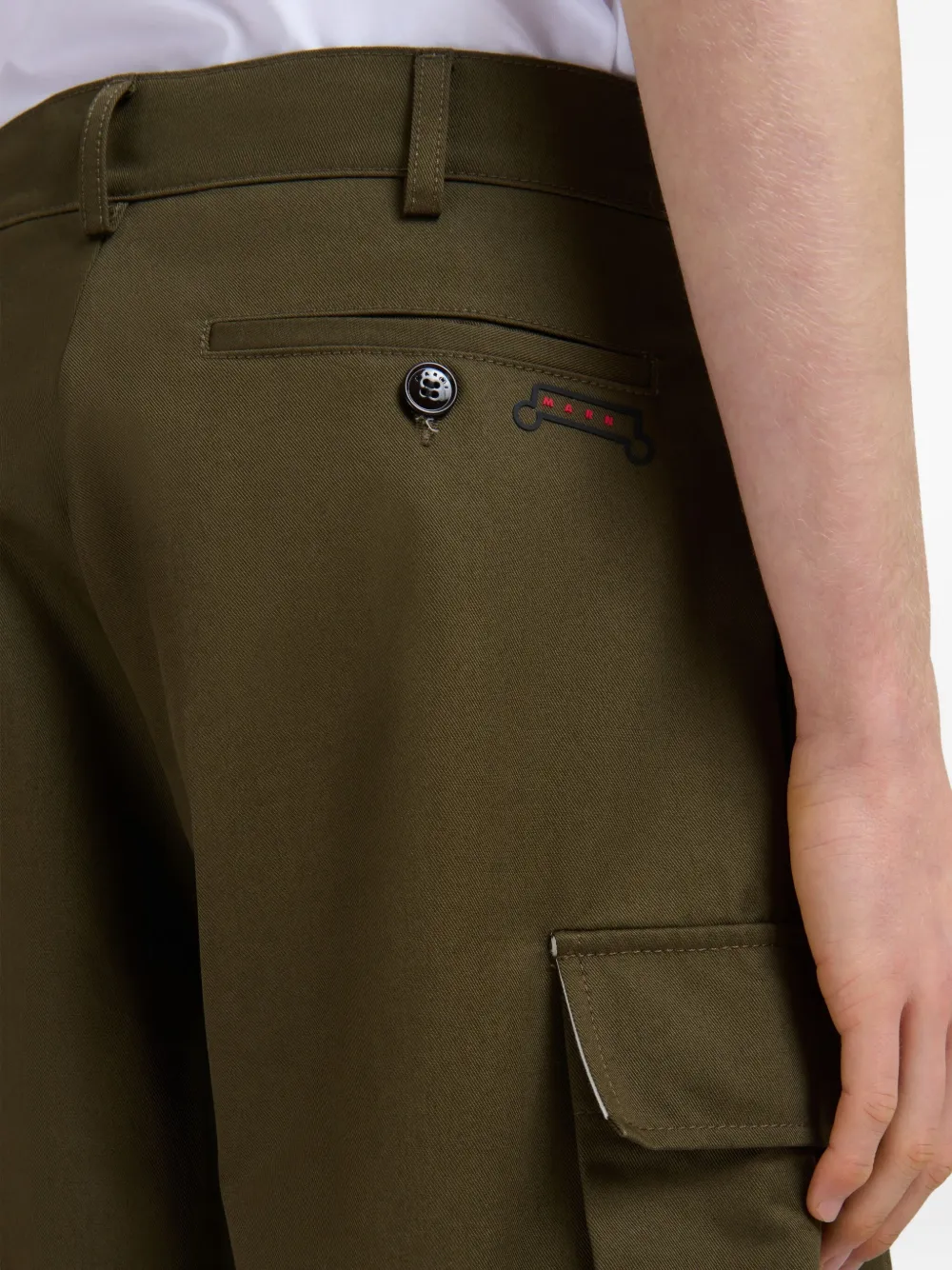 Close up of green shorts, showing texture of the cotton fabric