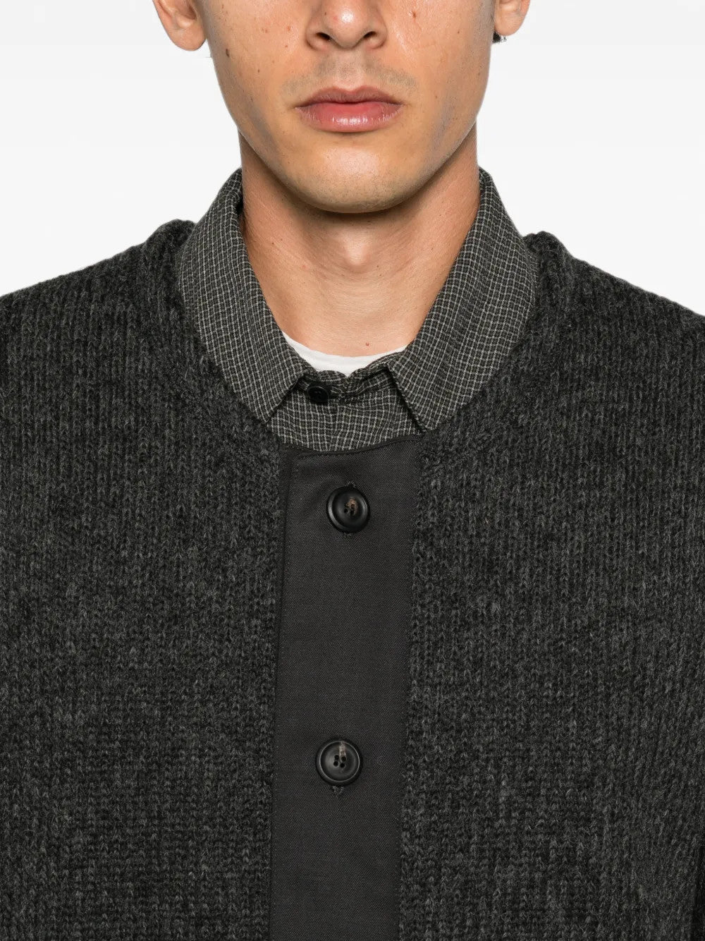 Grey knitwear worn by a person, showing the knitwear fit