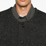 Grey knitwear worn by a person, showing the knitwear fit