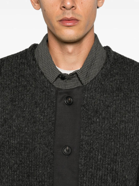 Grey knitwear worn by a person, showing the knitwear fit