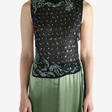 Green top worn by a person, showing the top fit