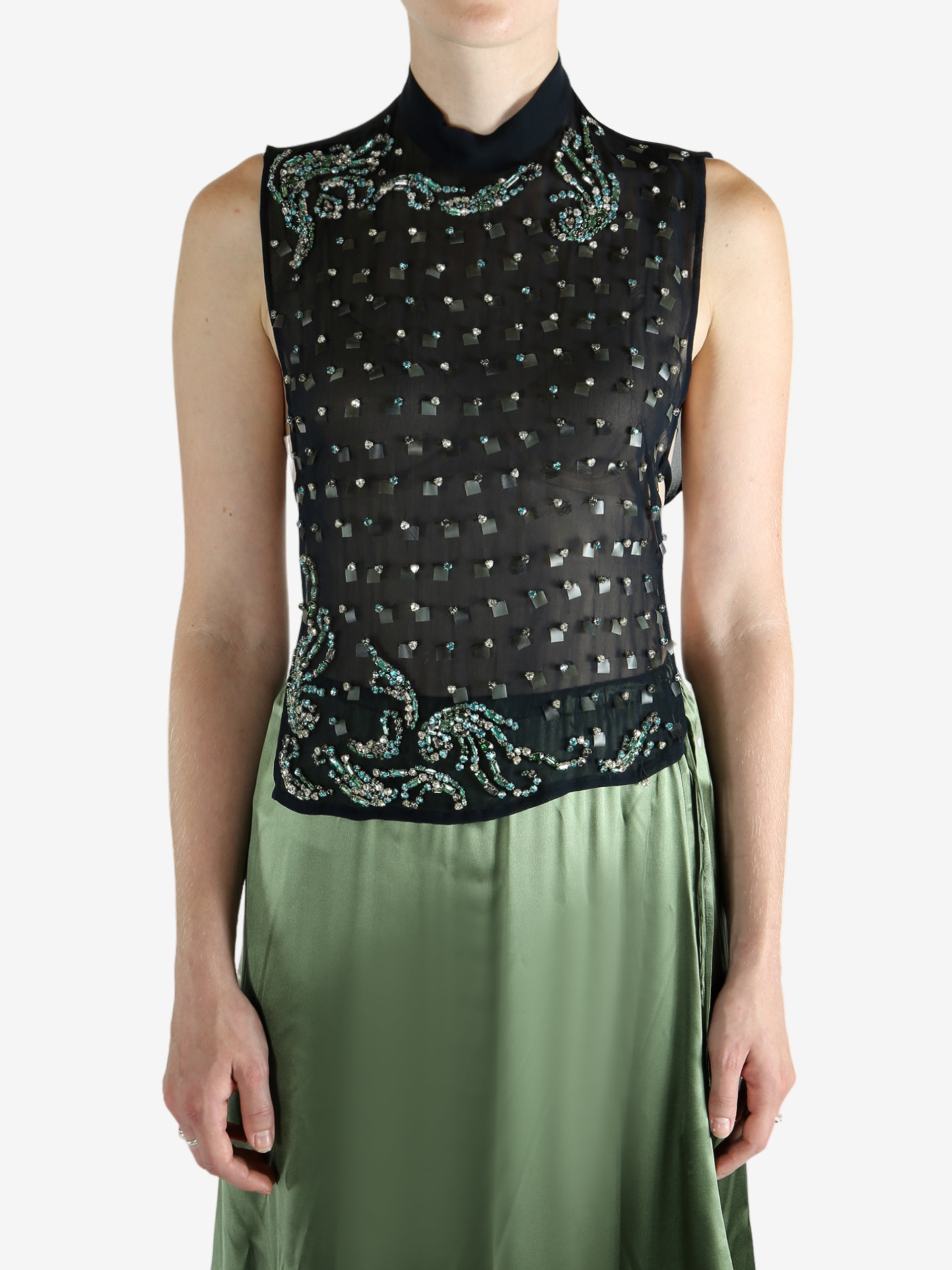 Green top worn by a person, showing the top fit