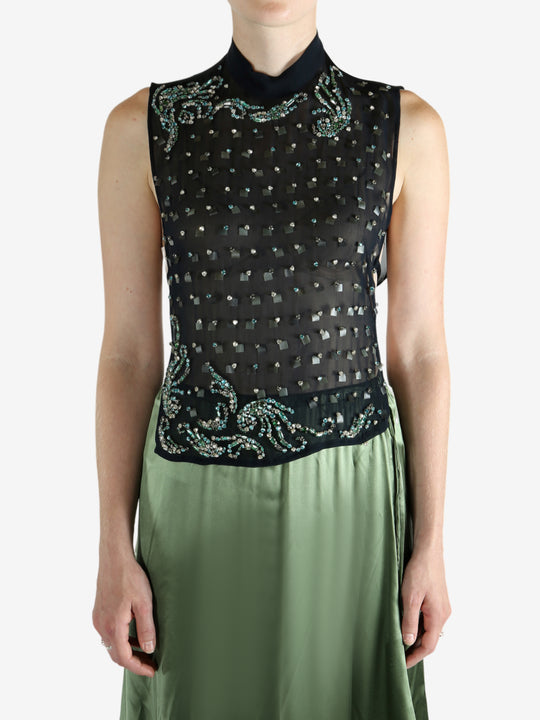 Green top worn by a person, showing the top fit