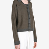 Green top worn by a person, showing the top fit