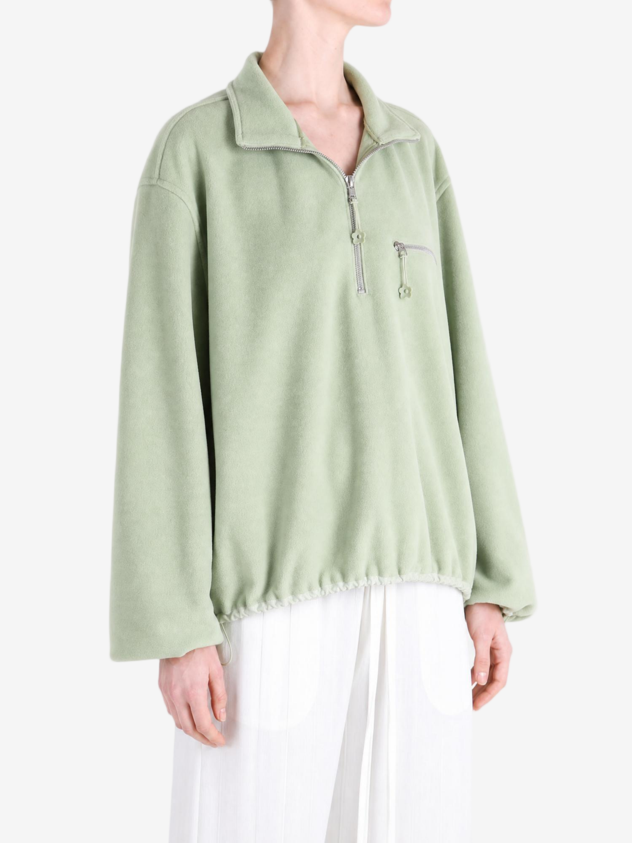 Green jacket worn by a person, showing the jacket fit