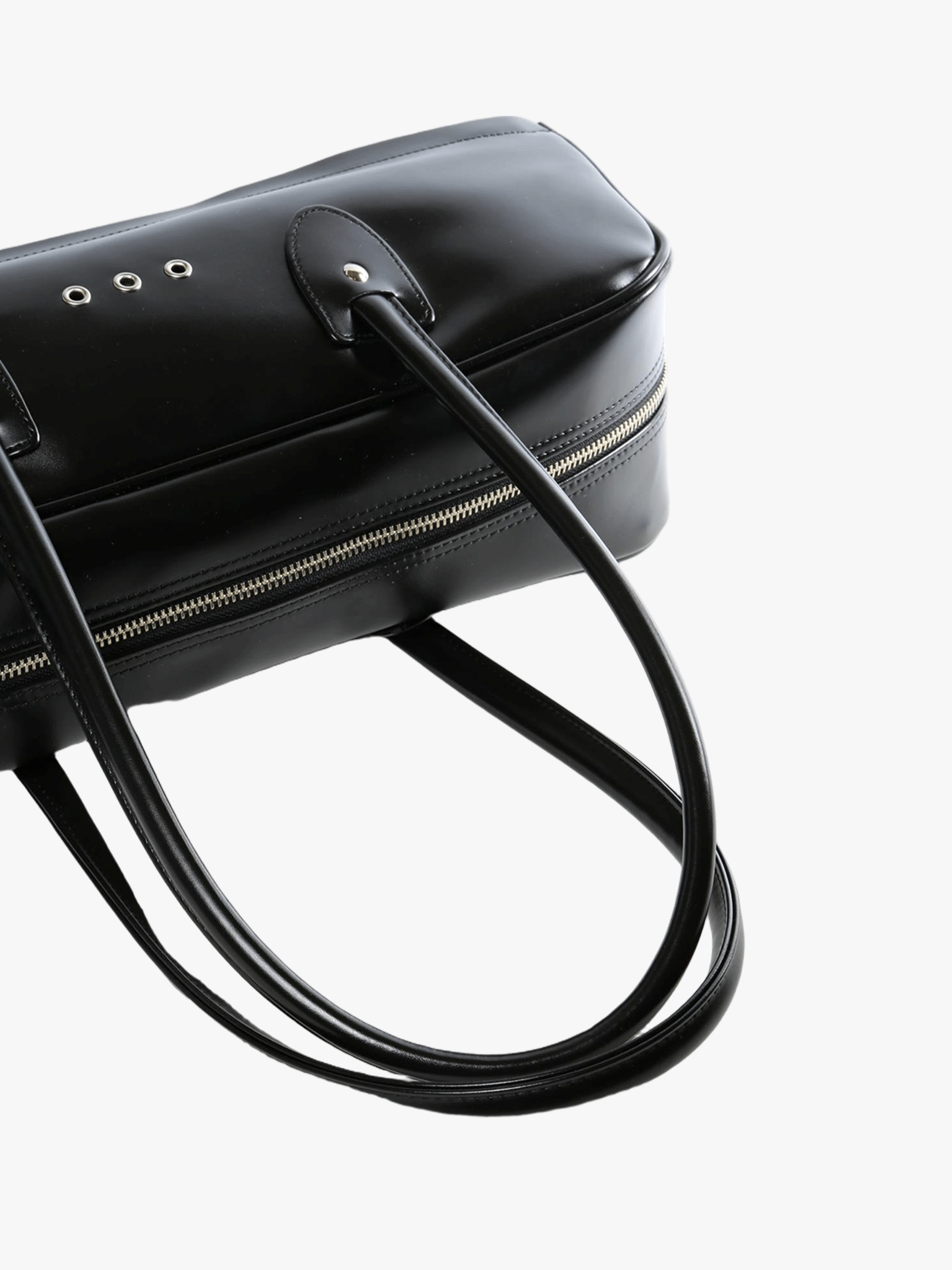 Close up of black handbag,showing texture of the polyethylene fabric.