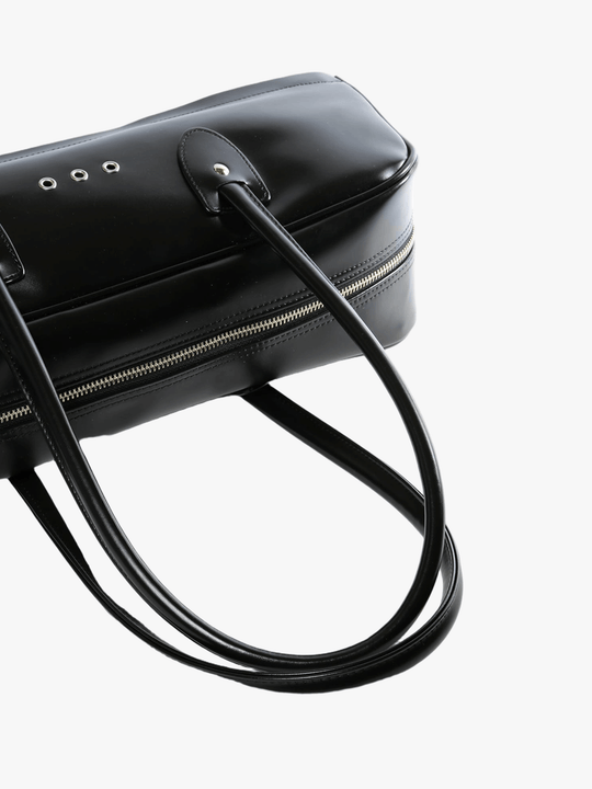 Close up of black handbag,showing texture of the polyethylene fabric.