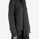 Grey knitwear worn by a person, showing the knitwear fit