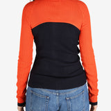 Orange top worn by a person, showing the top’s fit