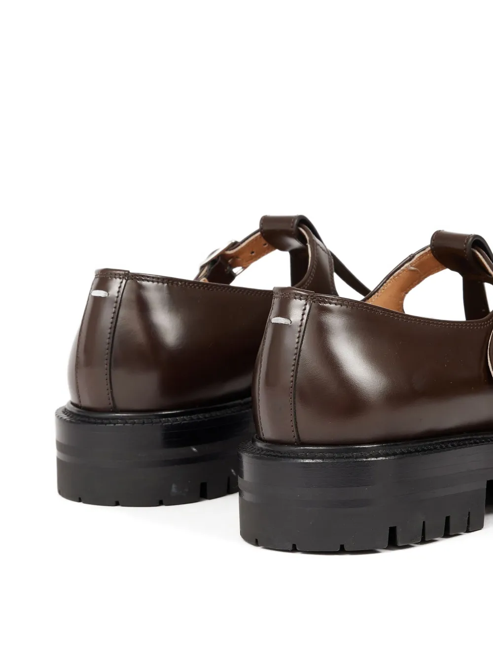 Close up of the brown shoes, showing texture of the leather fabric