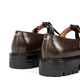 Close up of the brown shoes, showing texture of the leather fabric