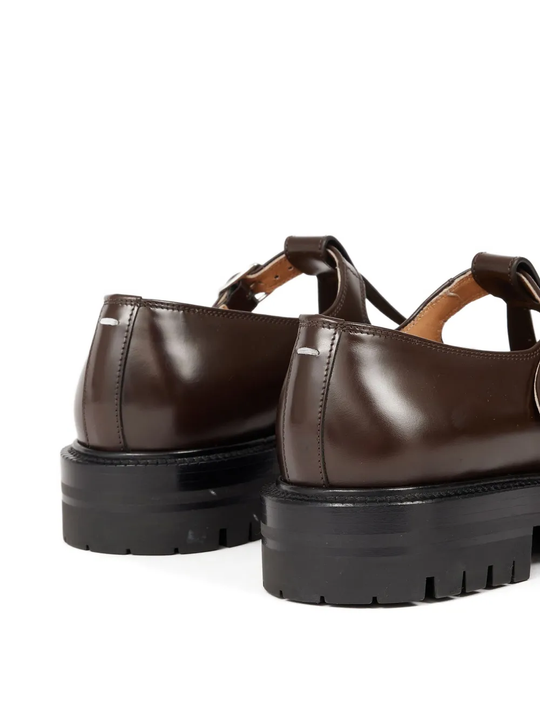 Close up of the brown shoes, showing texture of the leather fabric