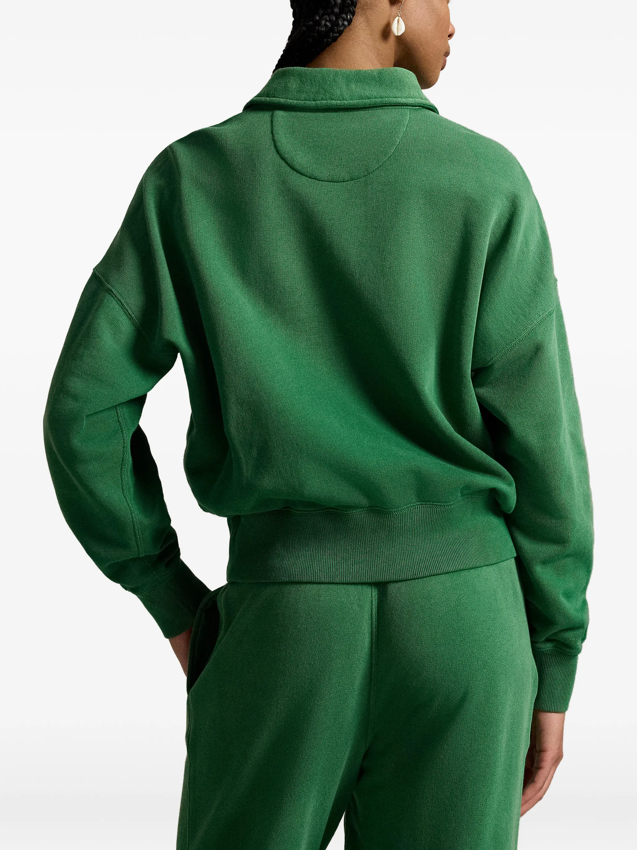 Green sweatshirt worn by a person, showing the sweatshirt‘s fit