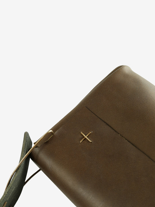 Close up of the green bag, showing texture of the leather fabric