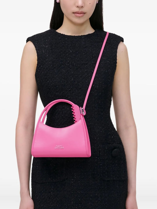 Pink bag worn by a person, showing the bag's fit