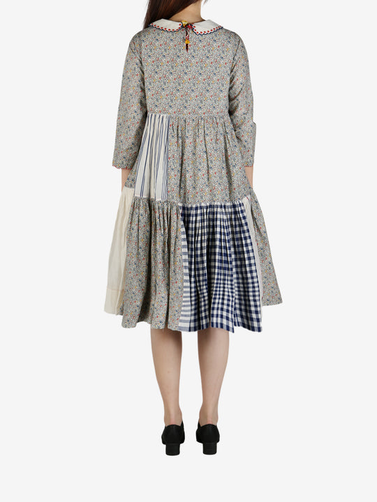 Grey dress worn by a person, showing the dress' fit