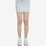 Grey skirt worn by a person, showing the skirt's fit