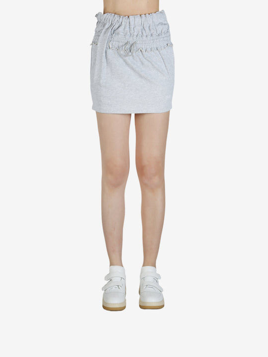 Grey skirt worn by a person, showing the skirt's fit