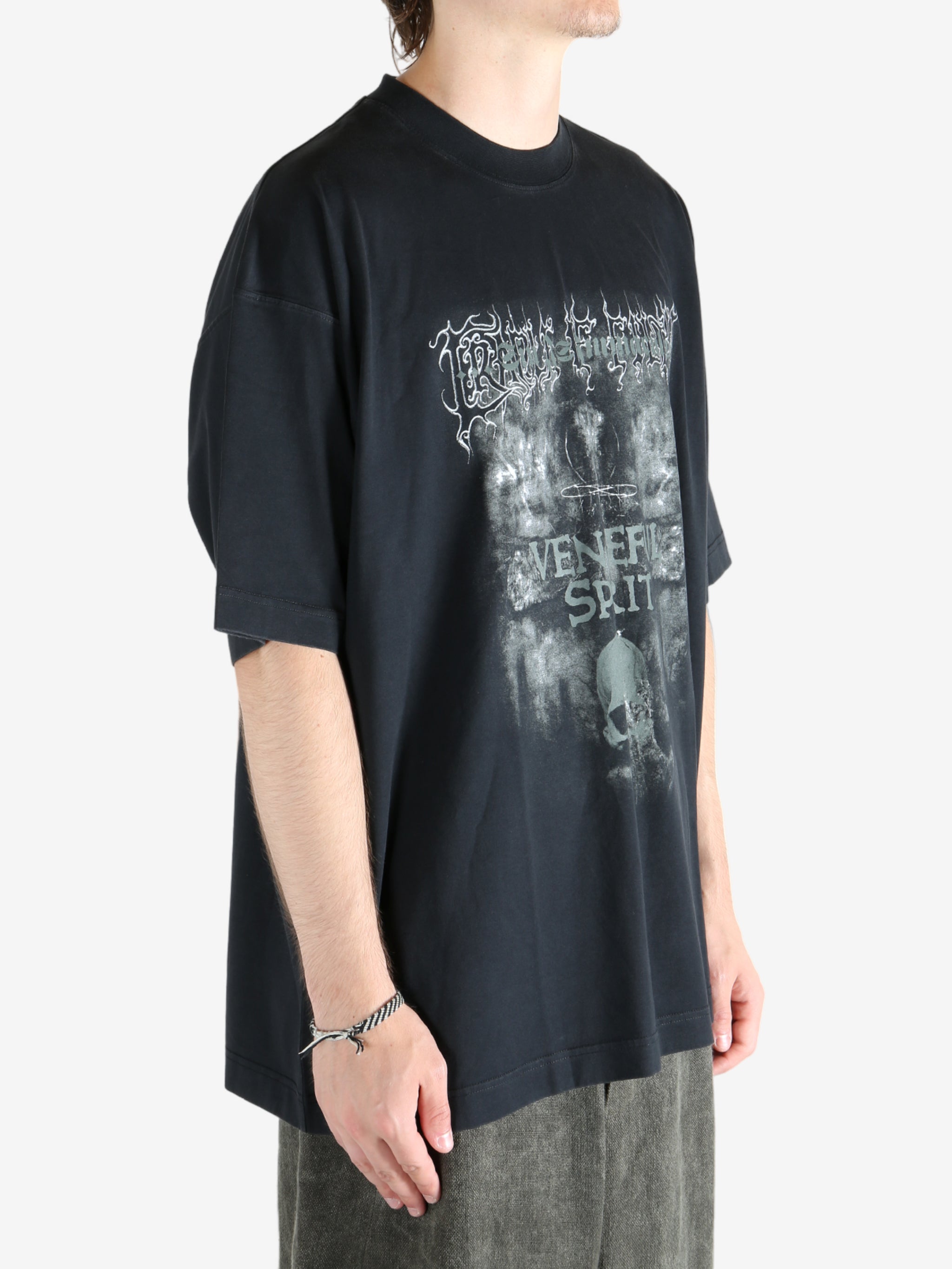 Black shirt worn by a person, showing the shirt fit