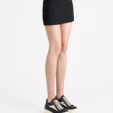 Black skirt worn by a person, showing the skirt fit