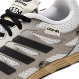 Close up of grey sneakers, showing texture of the fabric