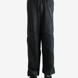 Black pants worn by a person, showing the pants' fit