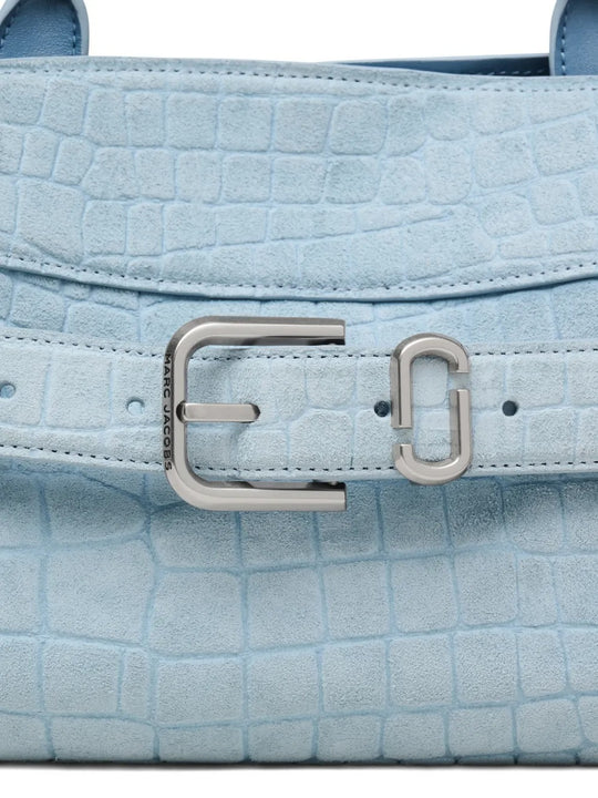 Close up of blue bags, showing texture of the suede cow leather fabric