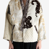 Tan coat worn by a person, showing the coat fit