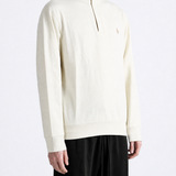 Tan knitwear worn by a person, showing the knitwear fit