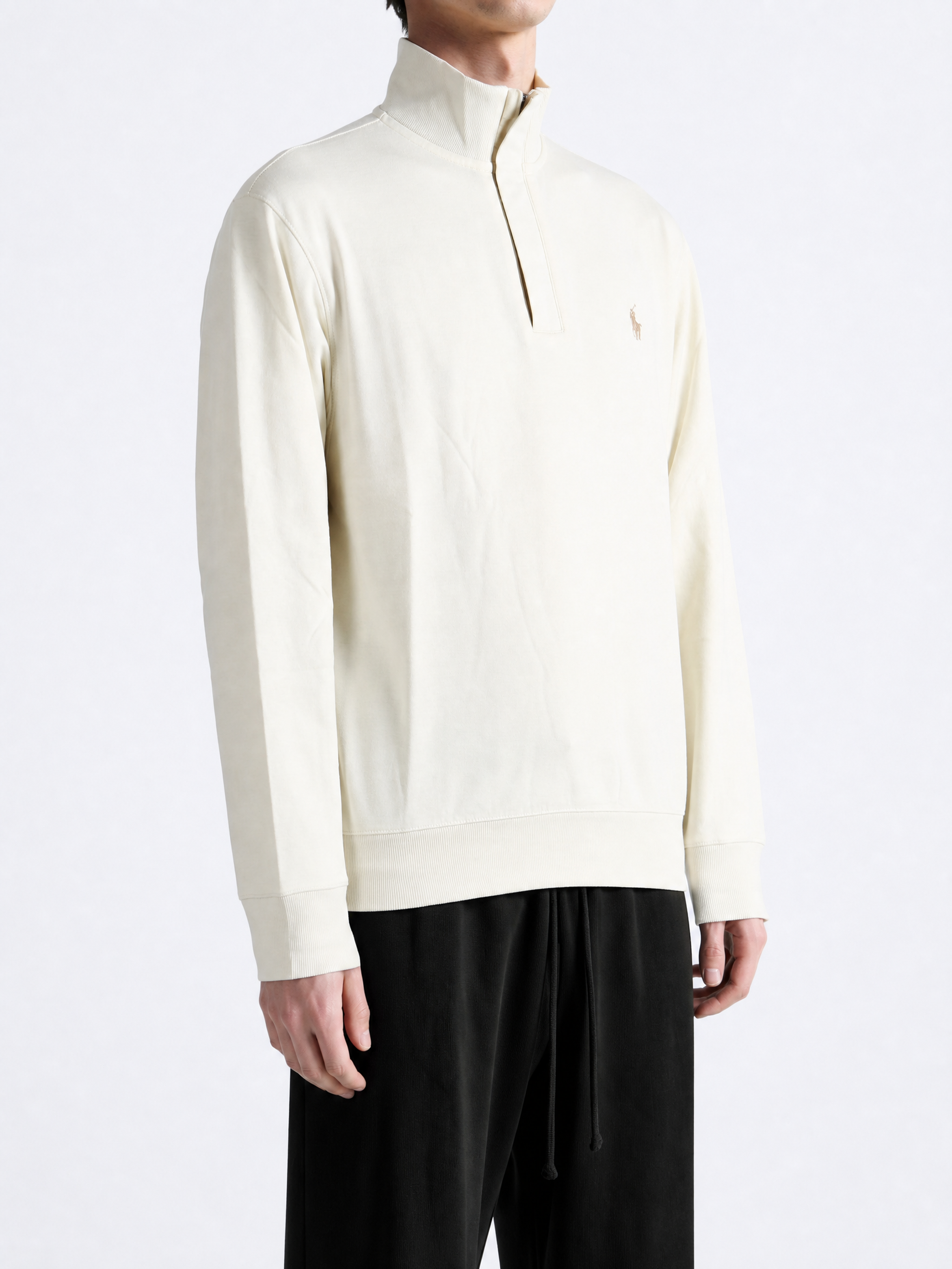 Tan knitwear worn by a person, showing the knitwear fit