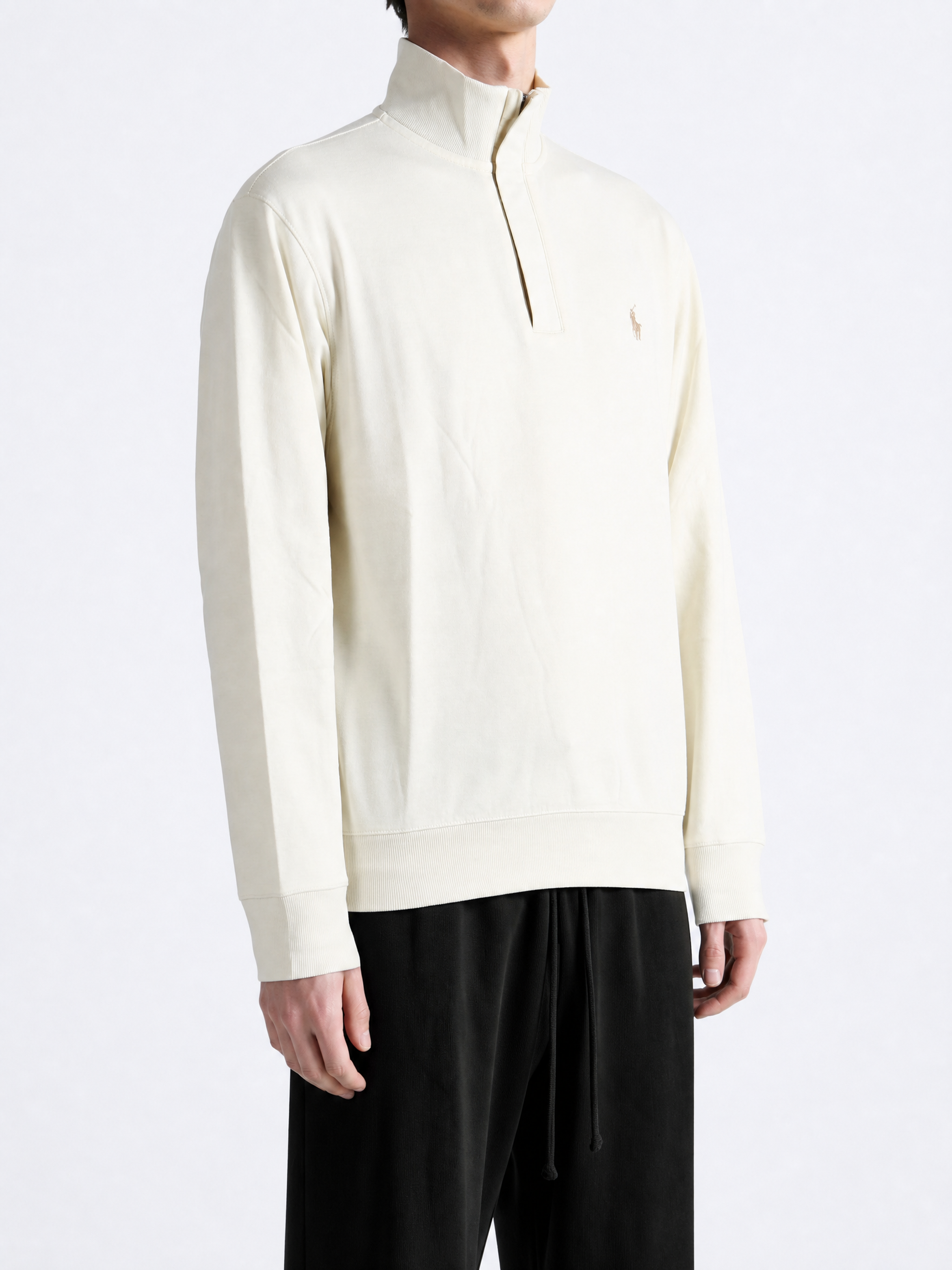 Tan knitwear worn by a person, showing the knitwear fit