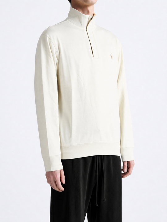 Tan knitwear worn by a person, showing the knitwear fit