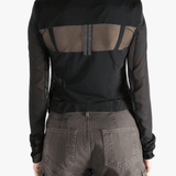 Black long sleeve worn by a person, showing the tight fit.