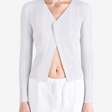 White knitwear worn by a person, showing the knitwear fit