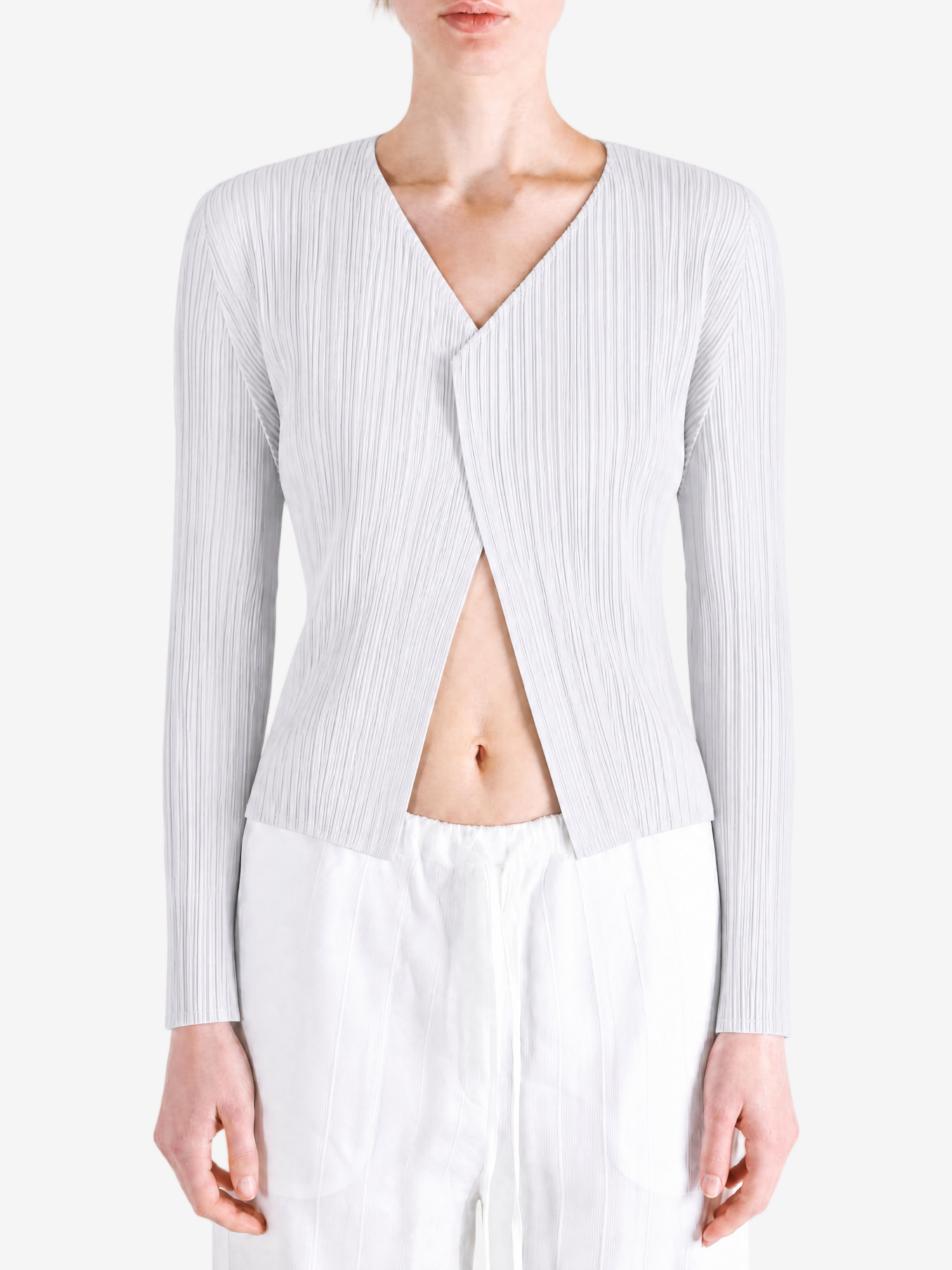 White knitwear worn by a person, showing the knitwear fit