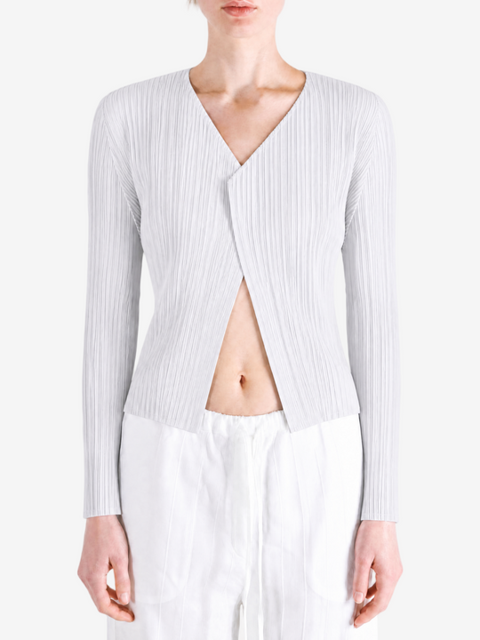 White knitwear worn by a person, showing the knitwear fit