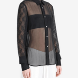 Black top worn by a person, showing the top fit