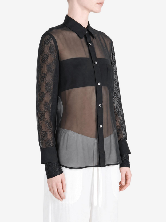 Black top worn by a person, showing the top fit