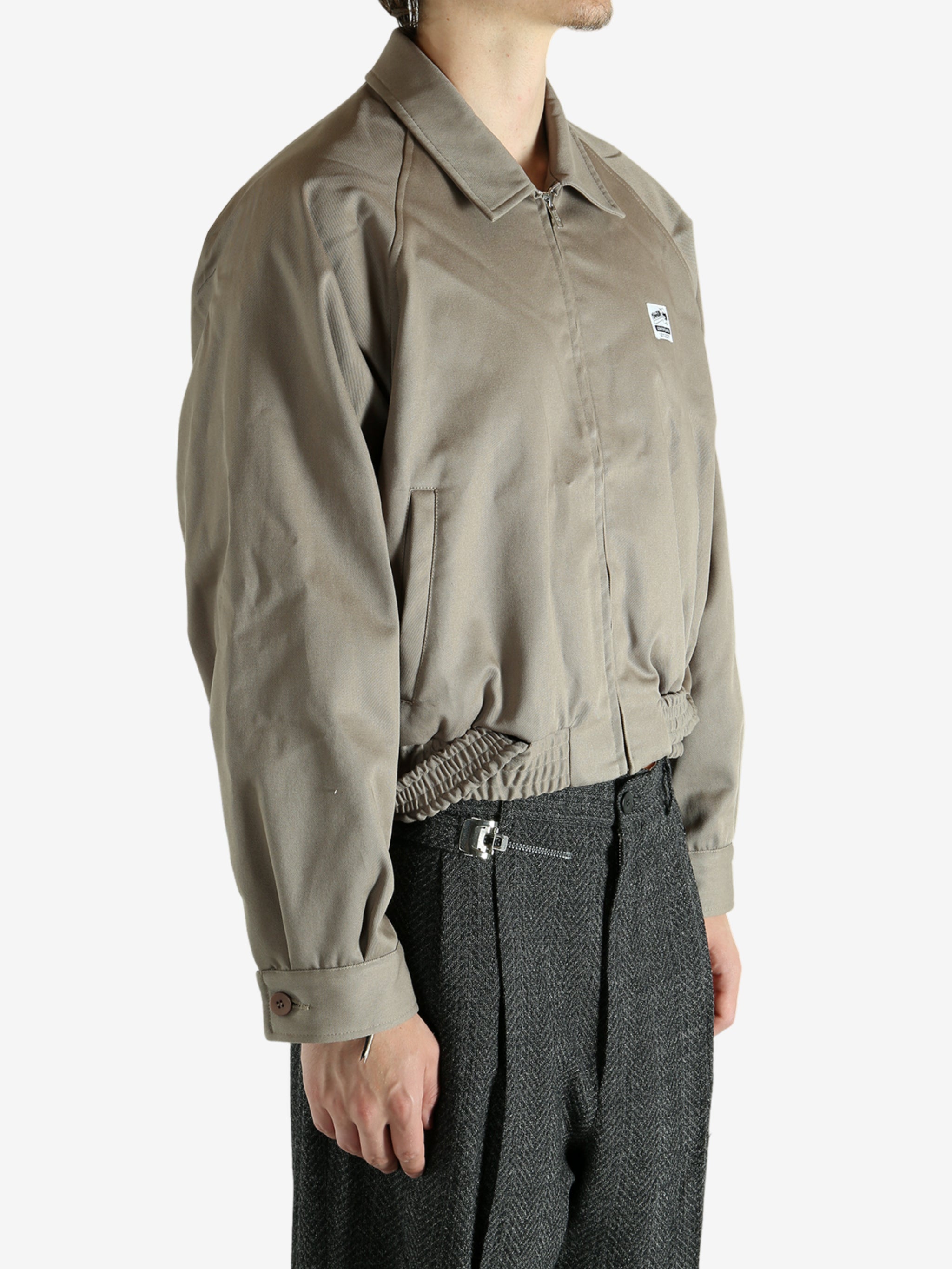 Tan jacket worn by a person, showing the jacket's fit