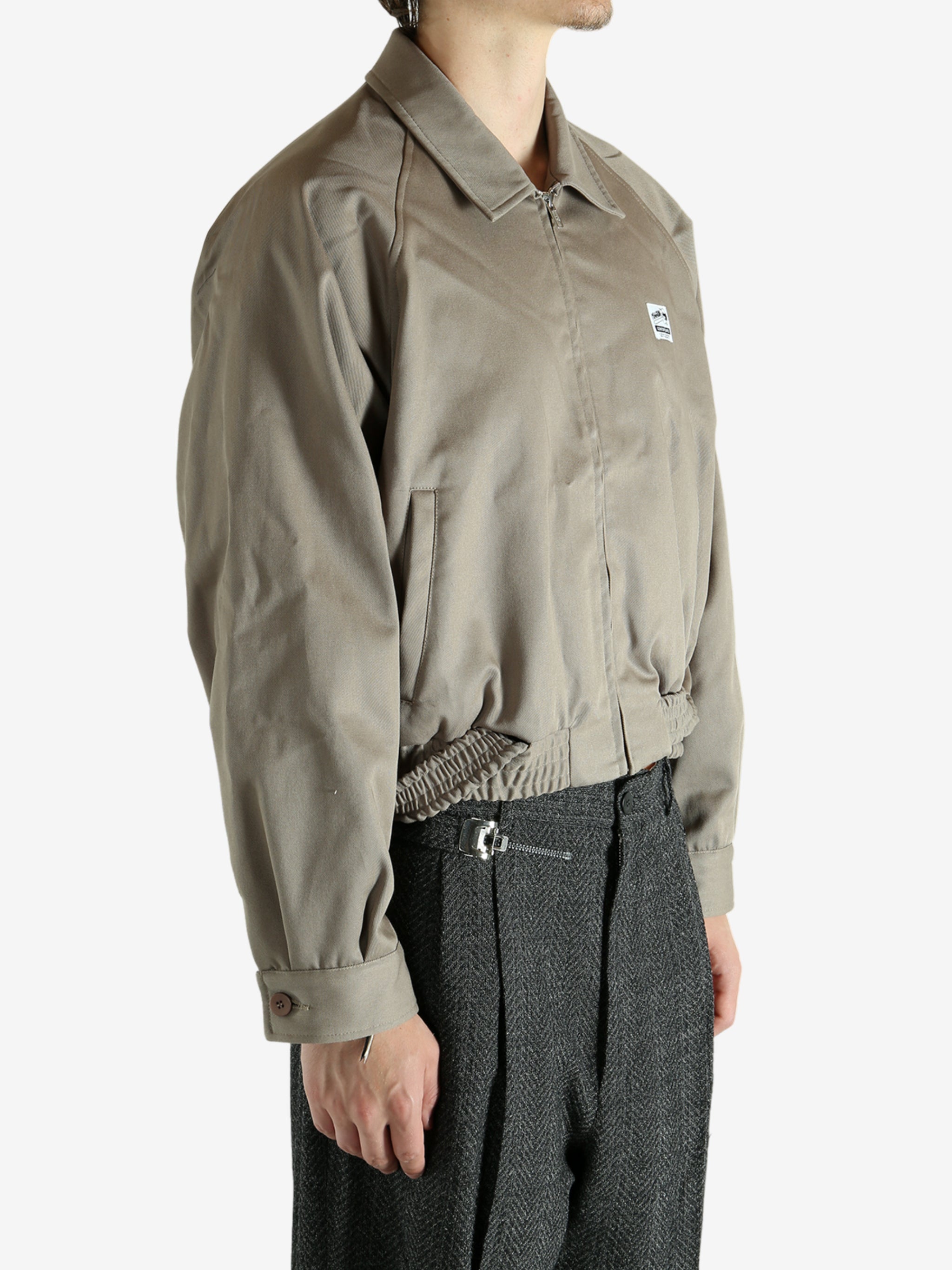 Tan jacket worn by a person, showing the jacket's fit